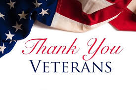 An American flag draped across the top of the image with the text “Thank You Veterans” written below in red and blue letters on a white background.